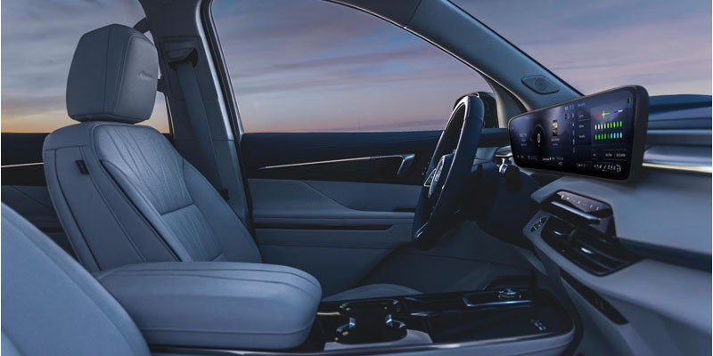 2026 Buick Enclave front cabin featuring a panoramic digital display and premium interior